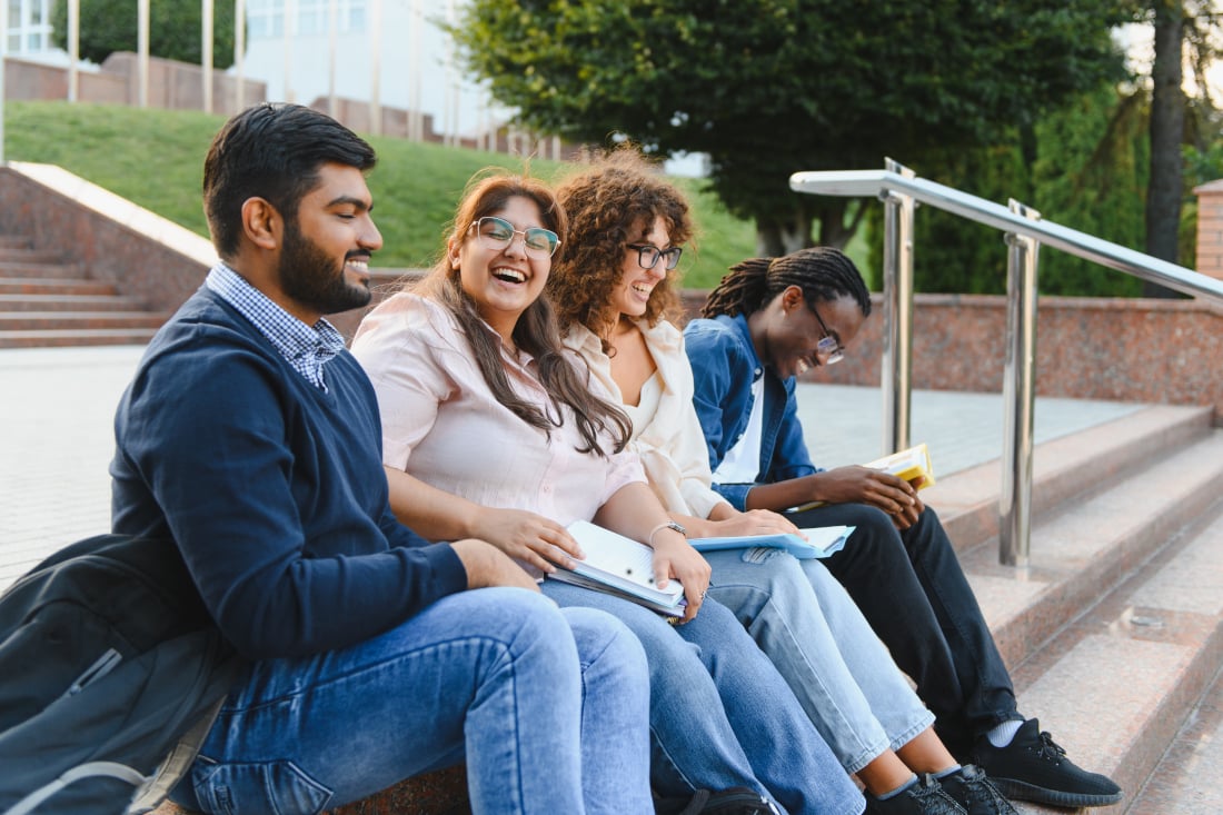 diverse-students-studying-together-on-campus-stair-2026-01-09-13-43-41-utc