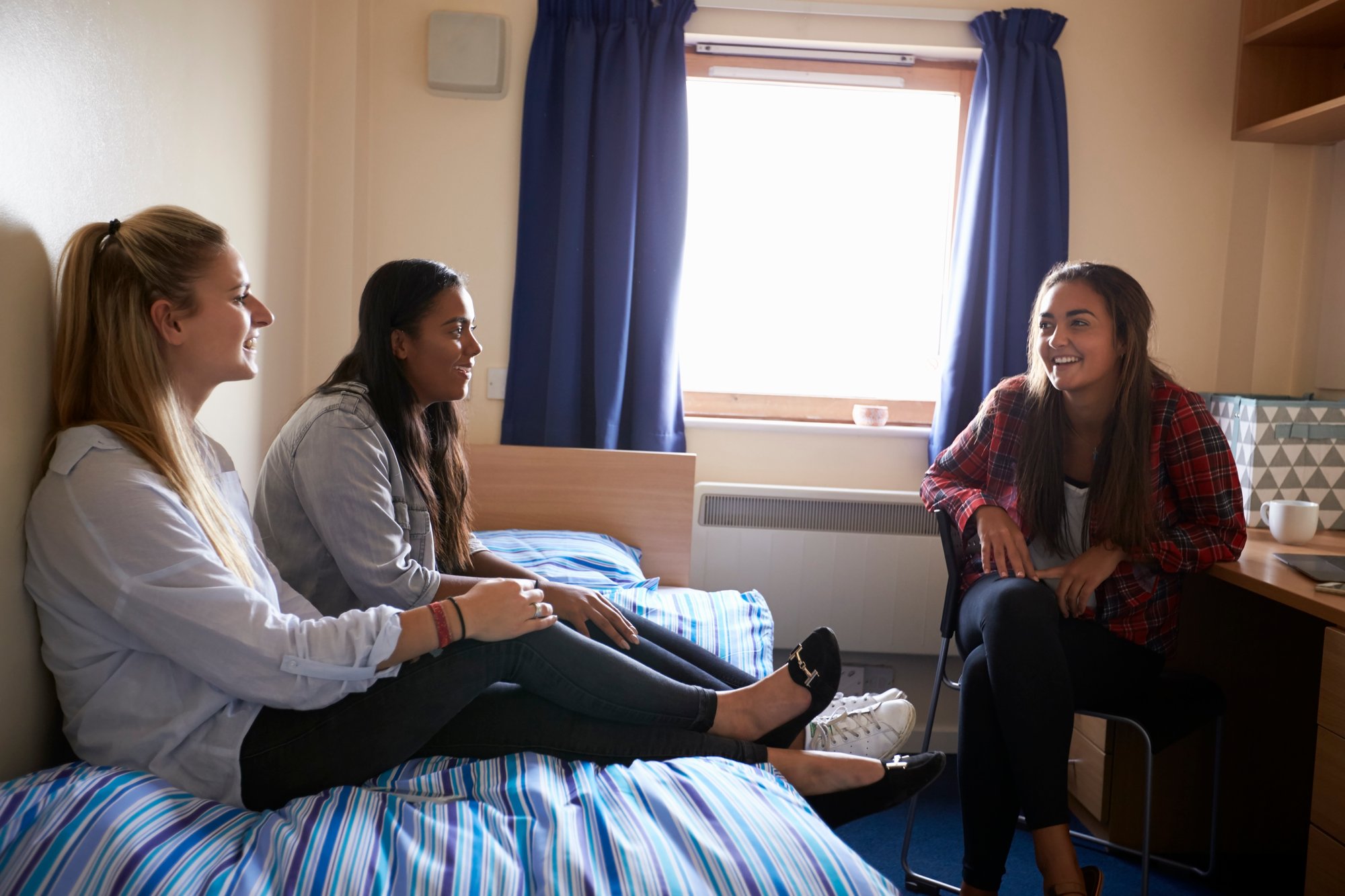 female-students-relaxing-in-bedroom-of-campus-acco-2024-10-20-10-22-26-utc