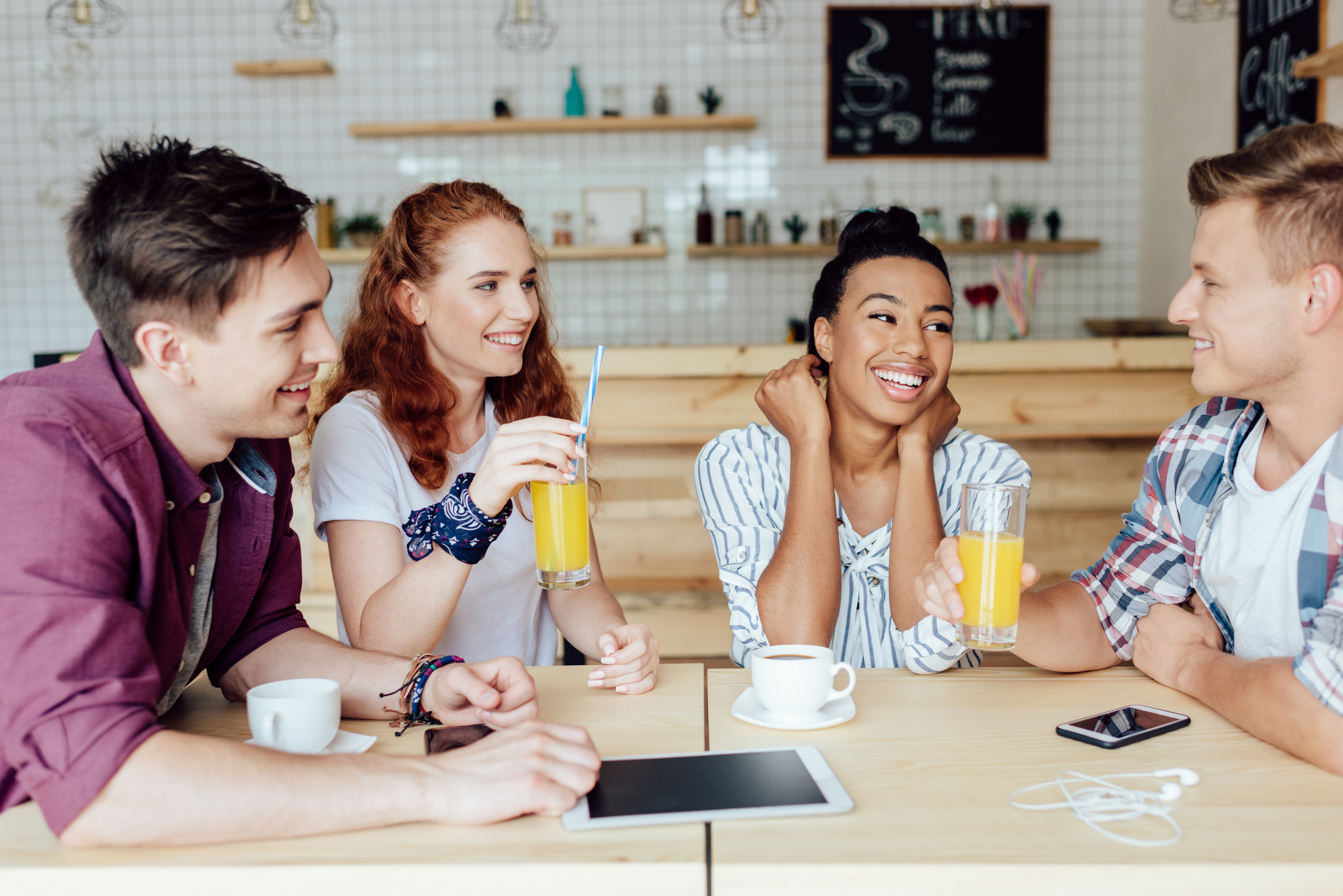 happy-young-multiethnic-friends-sitting-together-a-2024-11-18-04-55-28-utc