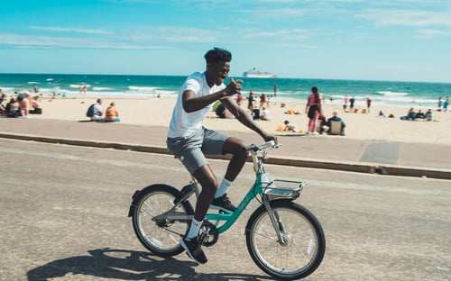 student cycling along bournemouth beach