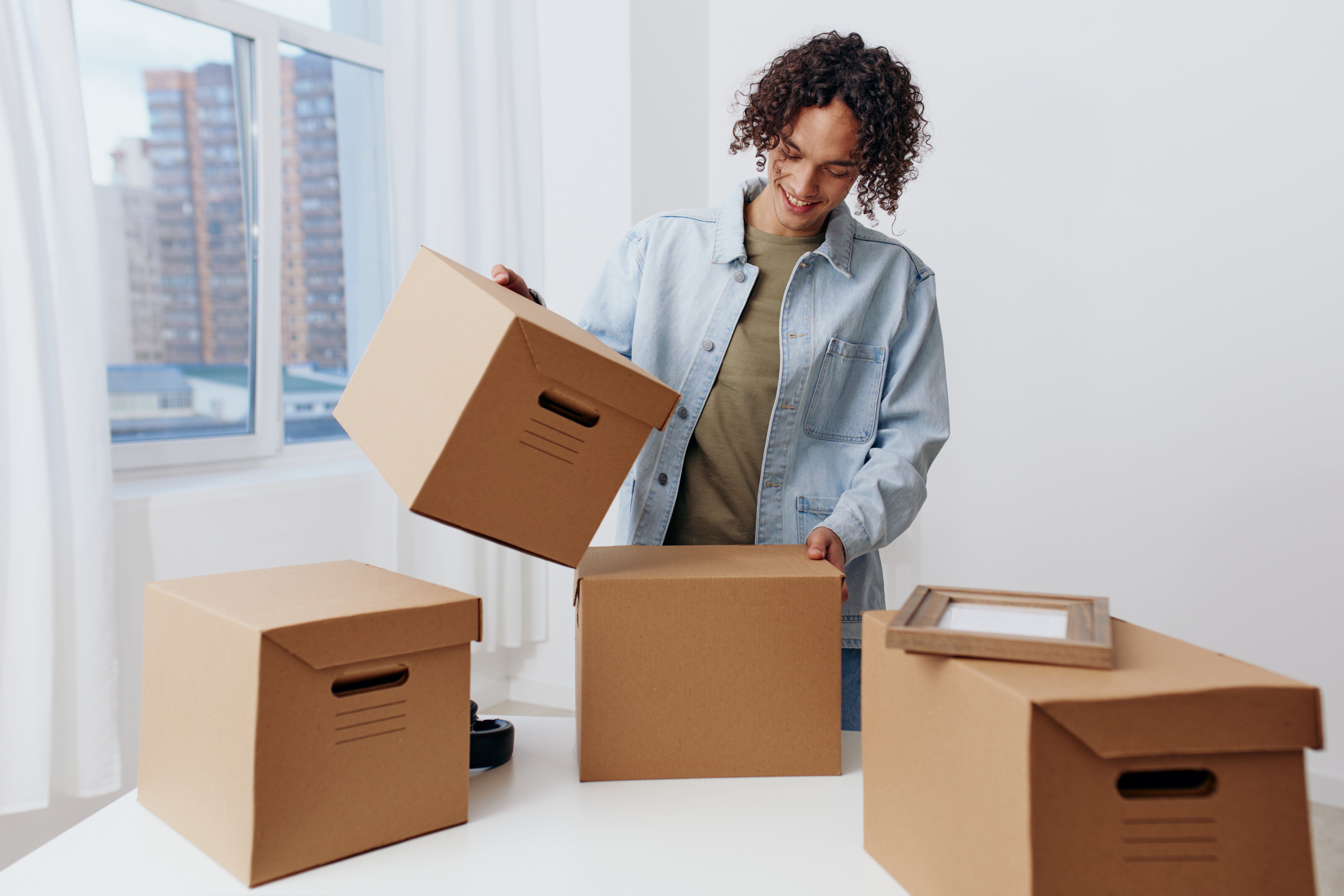 portrait-of-a-man-cardboard-boxes-in-the-room-unpa-2025-03-10-19-41-52-utc